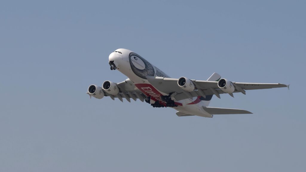 White and Red Airplane in Mid Air